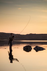 Fisherman working the high tide at Loch Cuin at sunset