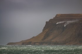 Waterfalls blowing upside down over the Ardmeanach headland