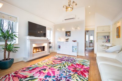 A painterly rug and stone fireplace make the living room a welcoming space