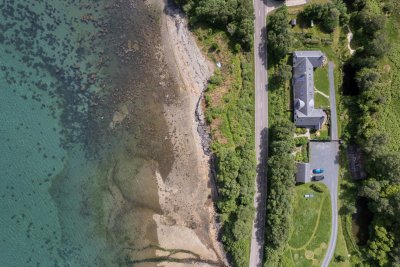 A bird's eye view of Daisy Cottage across the road from the sea shore