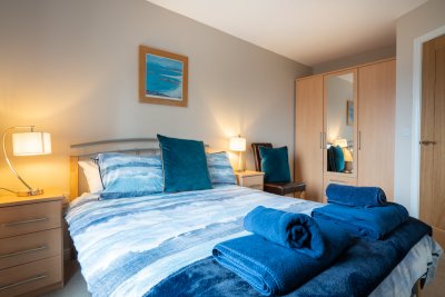 The second double bedroom at Daisy Cottage in soothing sea tones