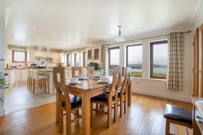 The dining kitchen has an open plan feel and invites you to enjoy the superb sea views