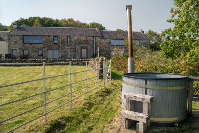 Slow down and enjoy a soak in the wood-fired hot tub at Gorsten House