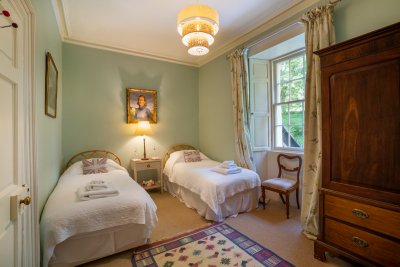 The second twin bedroom is lovely and light, enjoying woodland views
