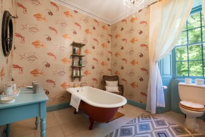 Roll-top bath tubs and carefully chosen wallpapers make even the bathrooms feel special in this character property