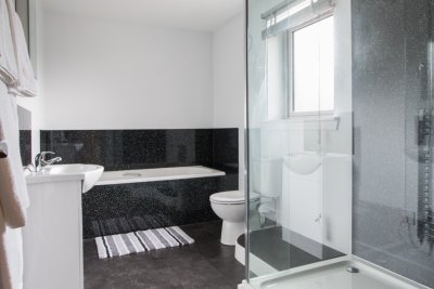 Family bathroom with large shower unit, bath and basin