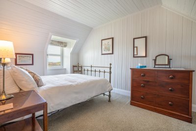Spacious upstairs double bedroom with antique furnishings