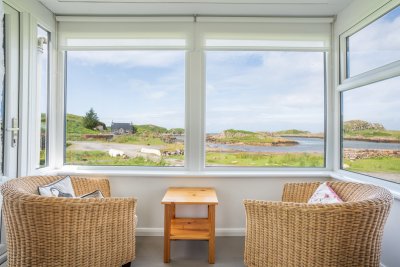 The sun room offers an idyllic spot to watch the sunset with a glass of wine in hand