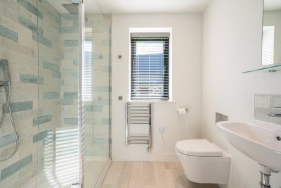En-suite bathroom that accompanies the twin bedroom with large walk-in shower, w.c, basin and heated towel rail