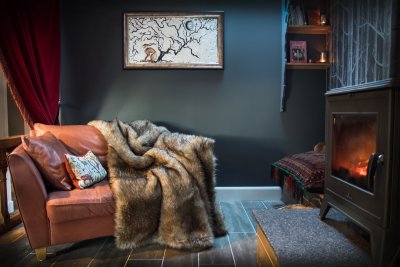 Fur throws and wood burning stove make this a romantic retreat