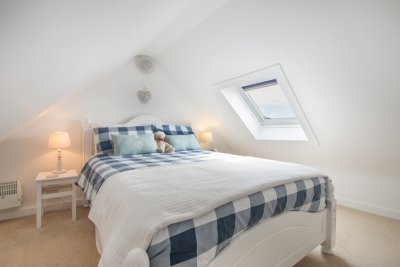 The second double bedroom has a very cosy feel with low coombed ceilings