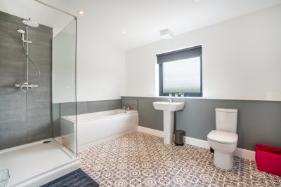 Spacious family bathroom with large walk-in shower and bath