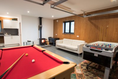 Superb games room with wood burning stove and seating area
