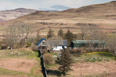 The Steading and agricultural shed viewed from across the loch