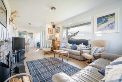 Lovely open plan living room and dining area to maximise the beach and sea views