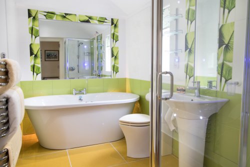 En-suite bathroom with spa bath, mood lighting and separate shower unit
