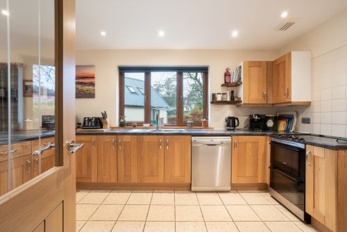 Guests will enjoy the spacious kitchen with modern appliances and quality cookware