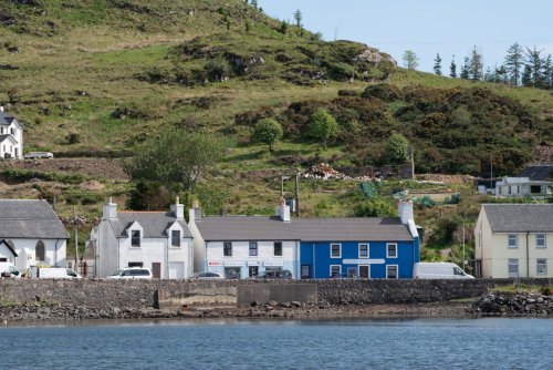 Fisherman's Loft spans the upper floor of the blue and the white buildings in Bunessan shown here