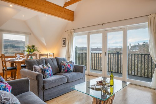 Enjoy a view to Loch Cuin from the balcony and living room at Half Moon House