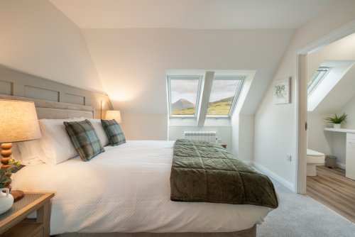 The upstairs double bedroom enjoys a mountain view too