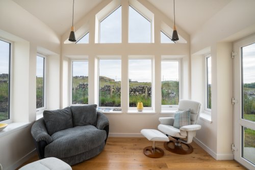 A favourite spot in the cottage, the sun room enjoys sea views