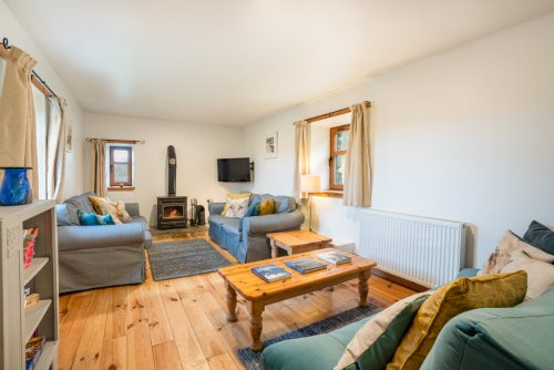 Settle in for a relaxing evening beside the wood burning stove at Torr na Locha
