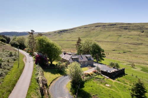 Achnacraig Cottage and the owner's adjoining home nestled into Glen Bellart