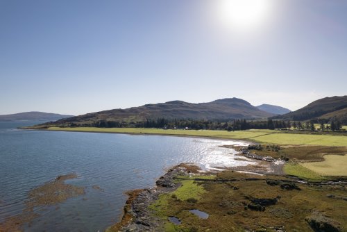 Looking along the coastline by the cottage, with the field used as an airstrip